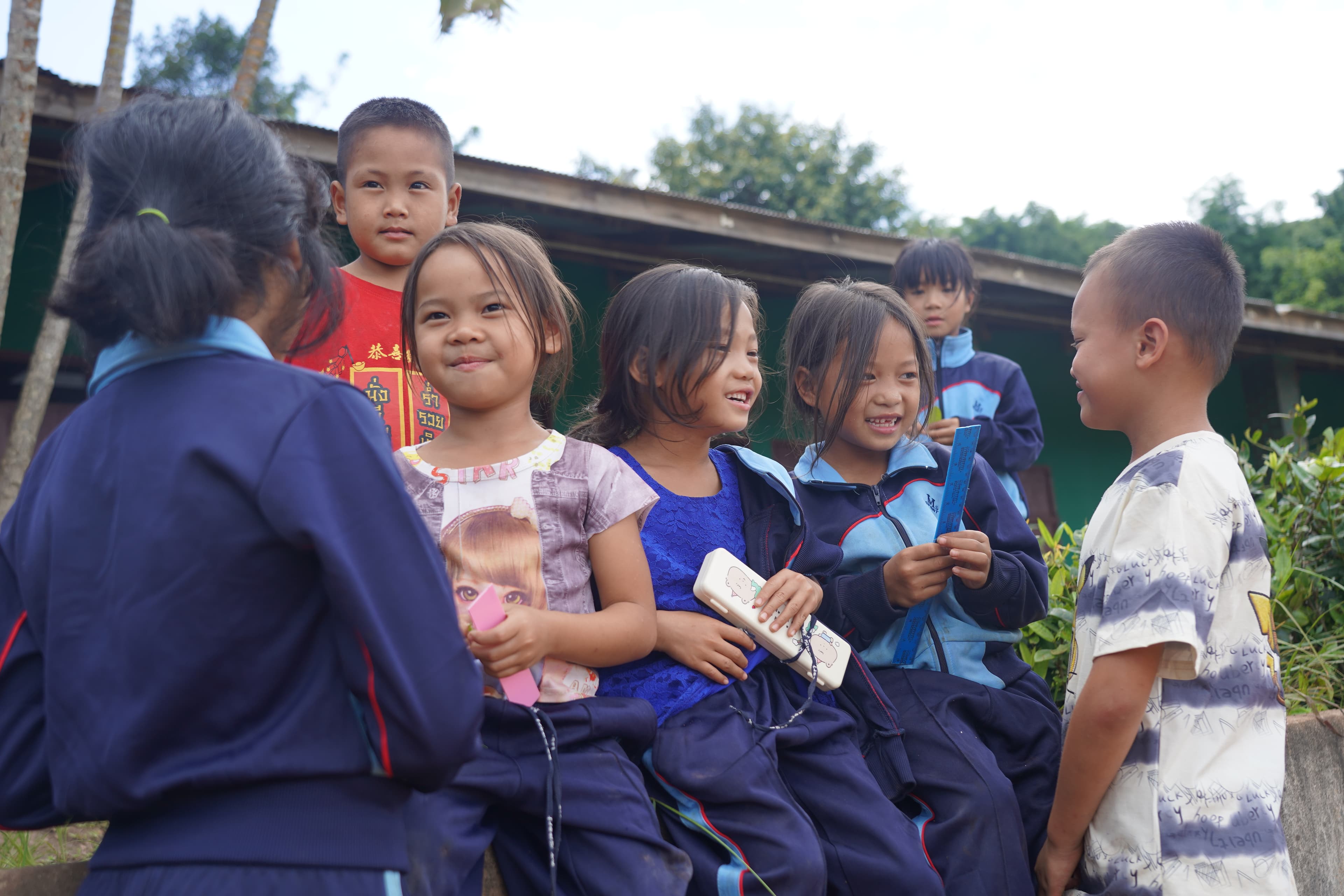 Primary school children laughing together outside their classroom